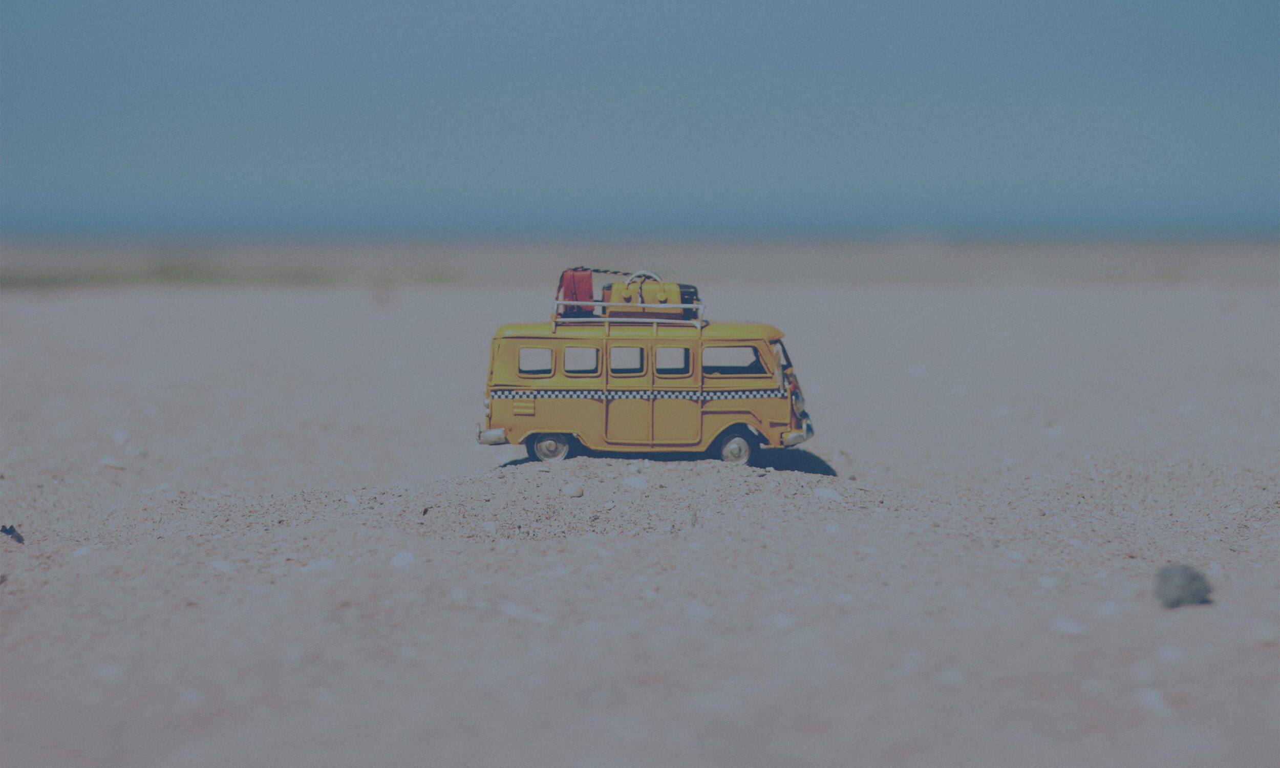 campervan toy on sand