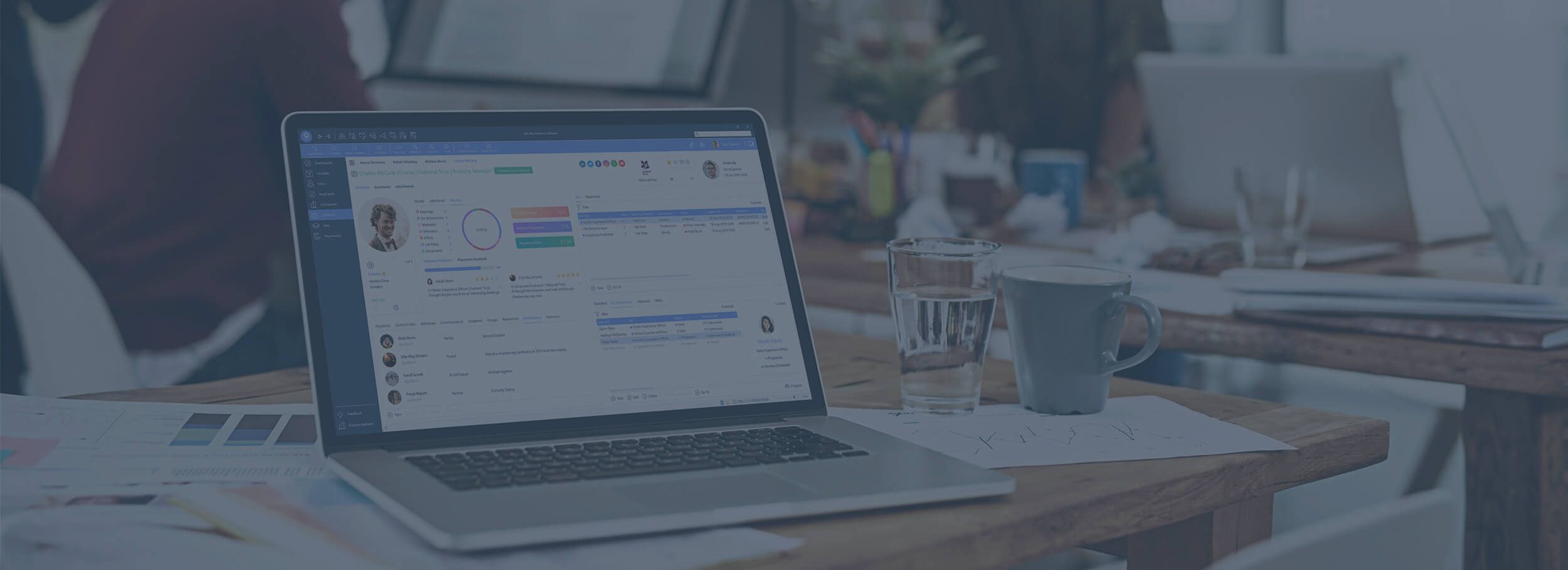 Laptop displaying itris 9 recruitment CRM and ATS in a modern office setting with a blue tint.